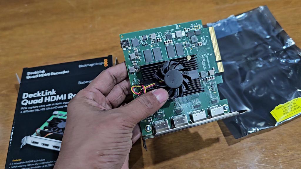 DeckLink Quad HDMI Recorder card held in hand