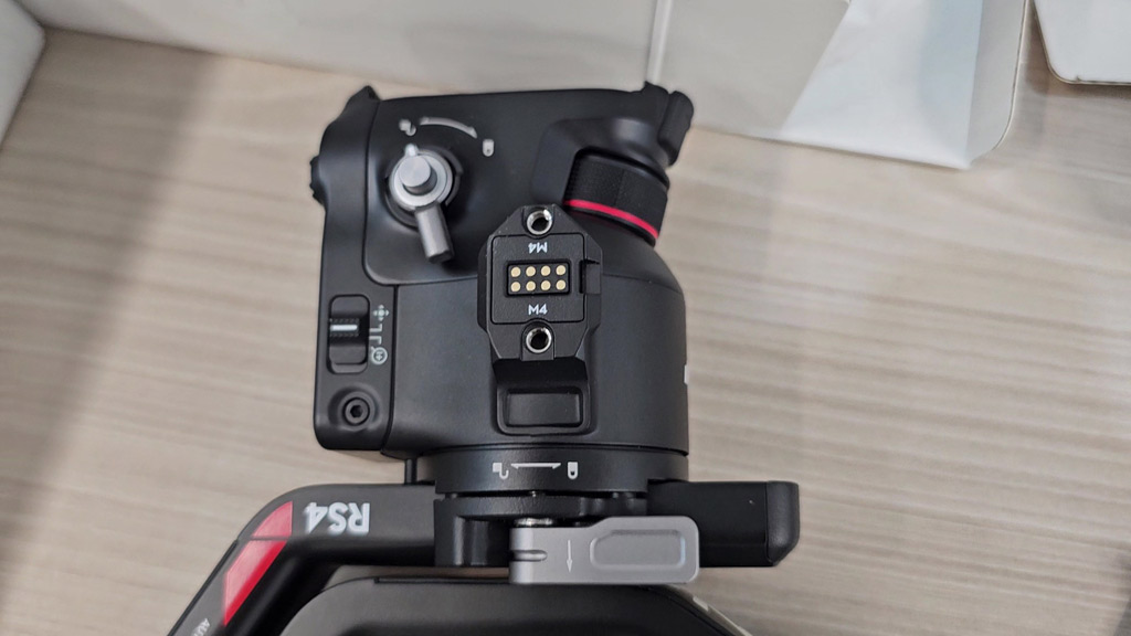 Close-up of the DJI RS 4 arm, lock lever and RS4 label