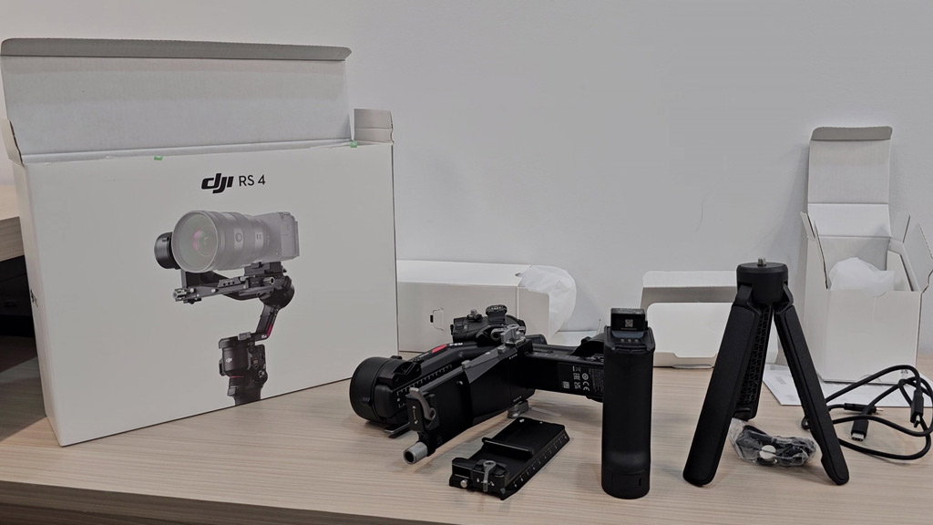 DJI RS 4 box contents: gimbal, battery grip, extended grip tripod, quick-release plate and cables