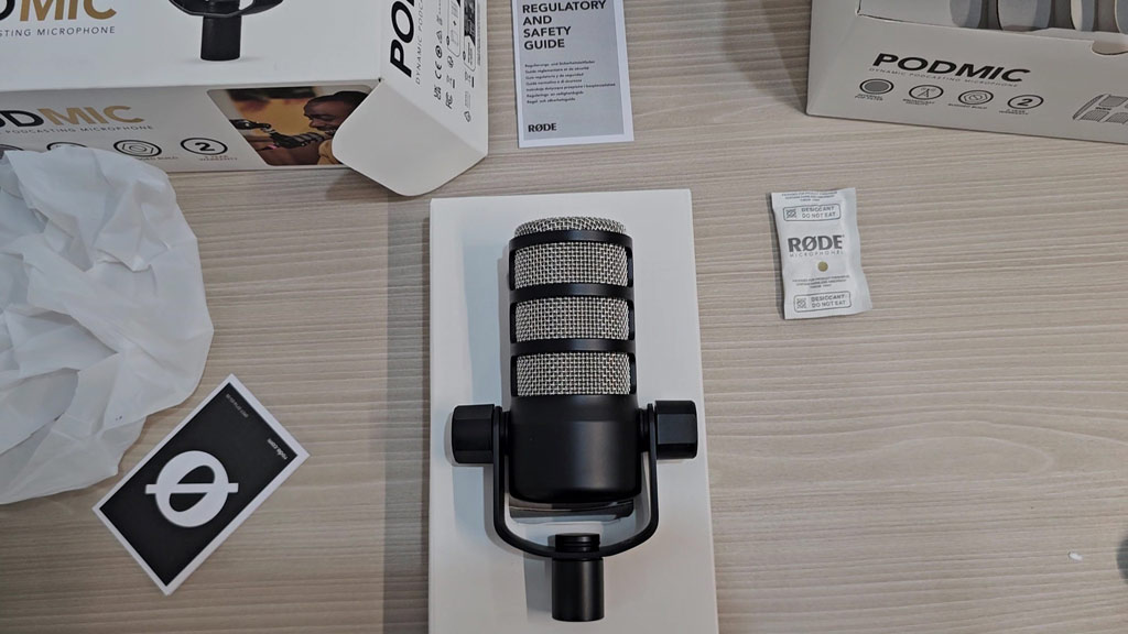 RØDE PodMic standing upright showing its metal body and grille