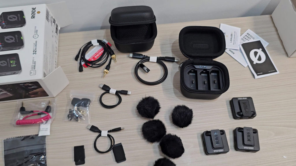 Full contents of the RØDE Wireless PRO kit laid out on a desk