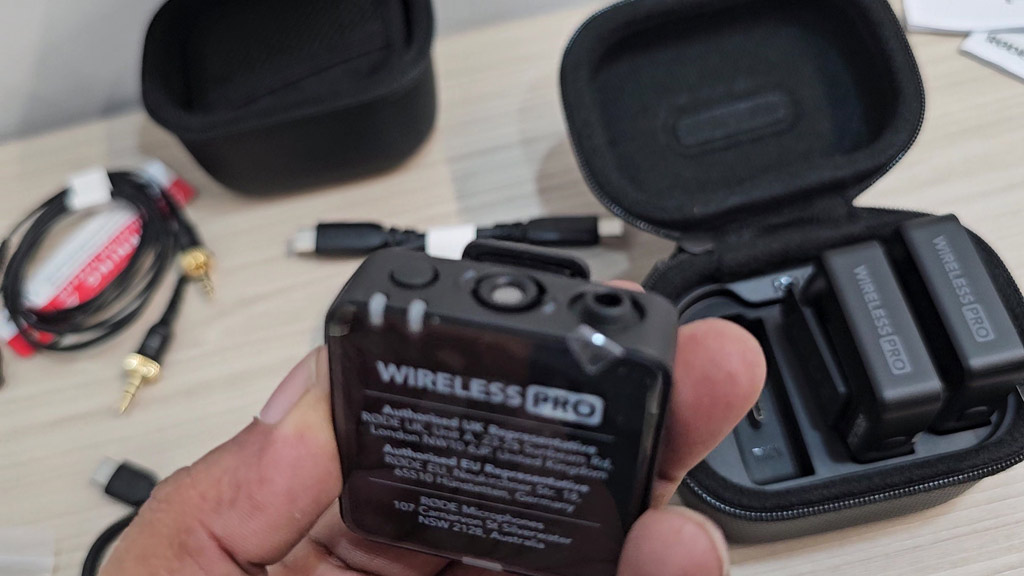 A RØDE Wireless PRO unit held in hand showing the Wireless PRO label