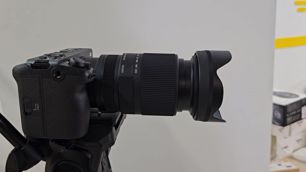 Sigma 16-300mm lens with hood mounted on a camera on a tripod